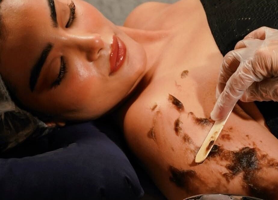 Client receiving a luxurious scrub treatment at Lolia Salon and Spa, Riyadh, Riyadh Province, SA.