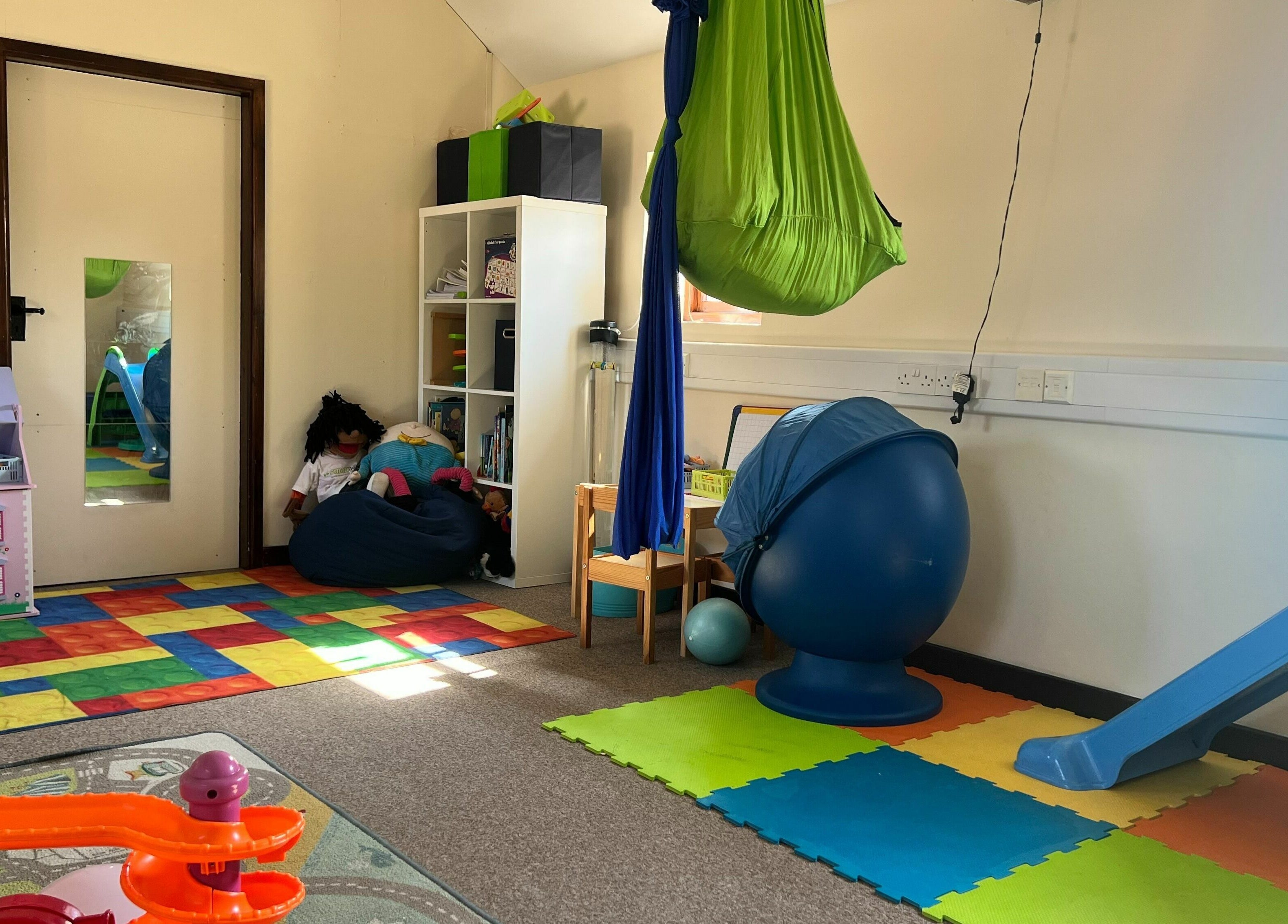 Colorful therapy playroom at Small Talk Speech and Language Therapy, Derby, England, GB, with toys and equipment.