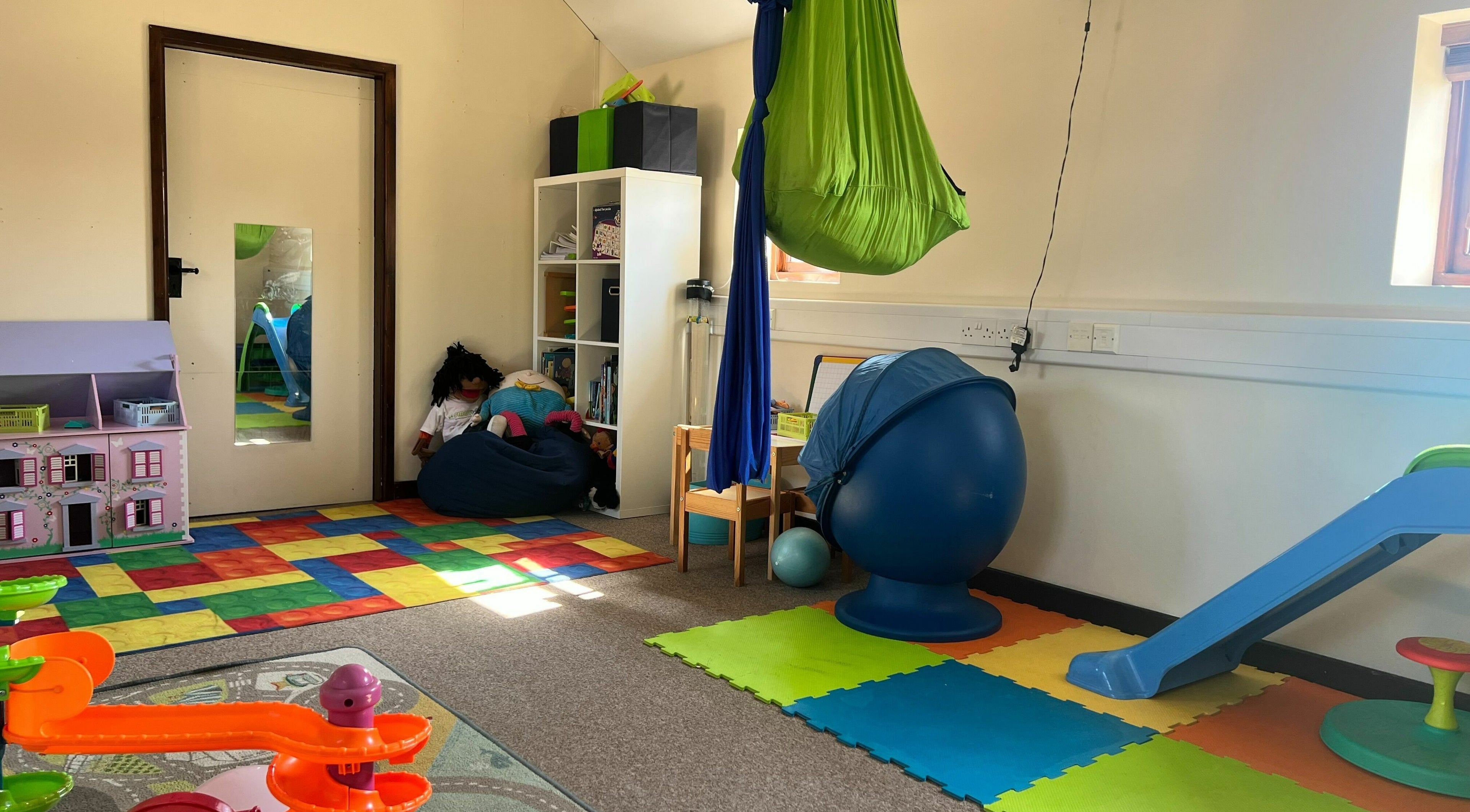 Colorful therapy playroom at Small Talk Speech and Language Therapy, Derby, England, GB, with toys and equipment.