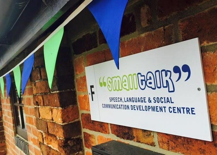 Exterior view of Small Talk Speech and Language Therapy in Derby, England, GB, showcasing a sign and colorful bunting.
