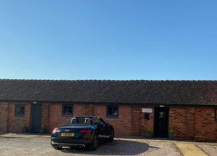 Charming brick building of Small Talk Speech and Language Therapy in Derby, England, GB under clear blue skies.