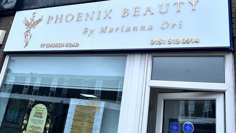 Facade of Phoenix Beauty By Marianna Ori in Wirral, England, GB showcasing elegant signage and invitation.