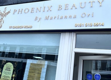 Facade of Phoenix Beauty By Marianna Ori in Wirral, England, GB showcasing elegant signage and invitation.
