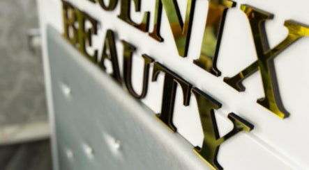 Elegant gold Phoenix Beauty By Marianna Ori sign at Wirral, England, GB amidst chic interiors.