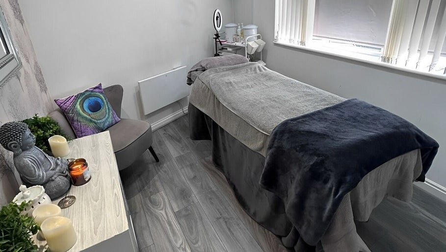 Relaxing treatment room at Phoenix Beauty By Marianna Ori, Wirral, England, GB, featuring a comfy massage bed.