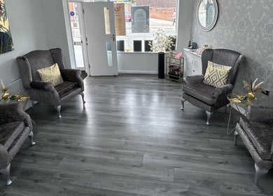 Elegant seating area at Phoenix Beauty By Marianna Ori, Wirral, England, GB, featuring plush chairs and decor.