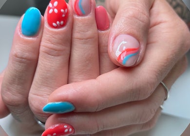Vibrant nail art featuring blue, red, and pink designs at Phoenix Beauty By Marianna Ori, Wirral, England, GB.