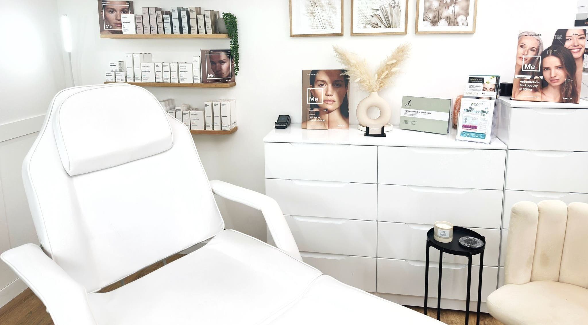 Modern treatment room at The Good Skin Clinic, Peterborough, England with a white chair and skincare products.