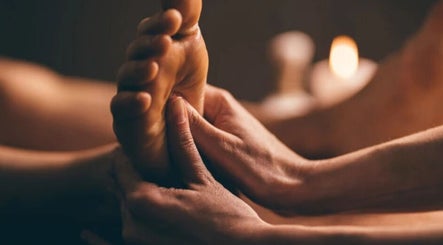 Foot massage at Ten Toes Reflexology, Lawrence, Kansas, US with candlelit ambiance for ultimate relaxation.