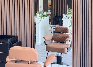 Elegant salon interior at Hair Moment, Rowland Heights, California. Stylish chair and mirror enhance modern vibe.