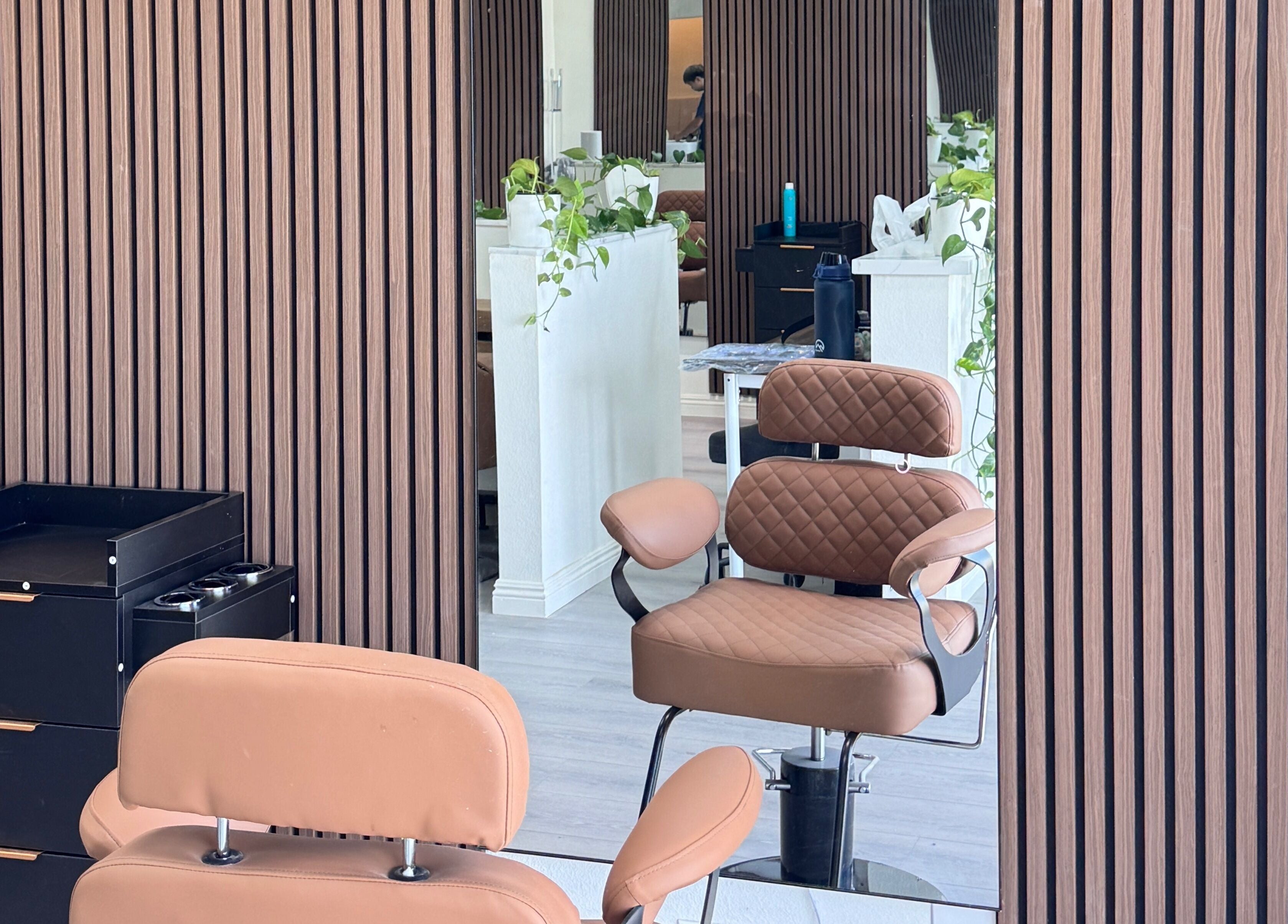Elegant salon interior at Hair Moment, Rowland Heights, California. Stylish chair and mirror enhance modern vibe.