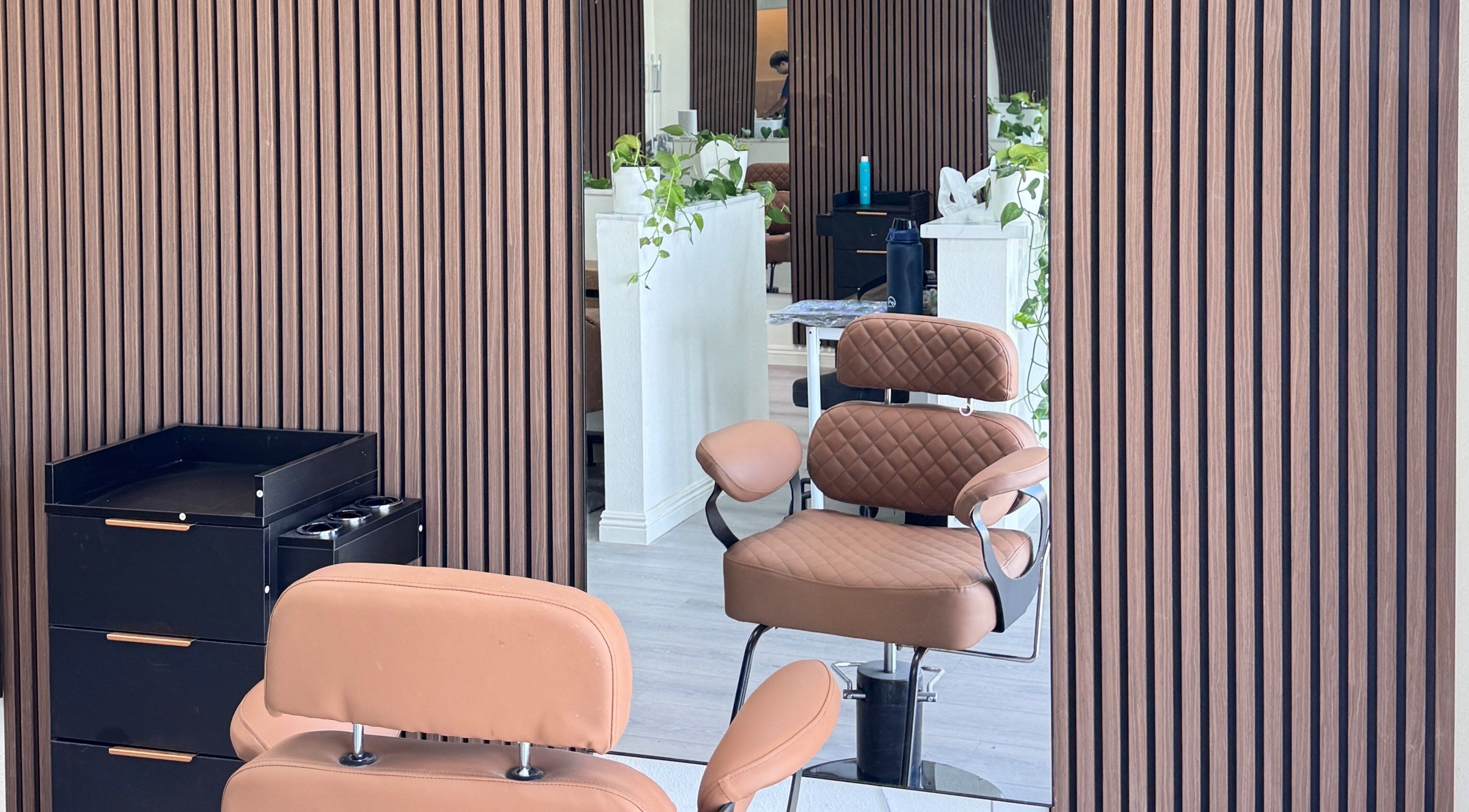 Elegant salon interior at Hair Moment, Rowland Heights, California. Stylish chair and mirror enhance modern vibe.