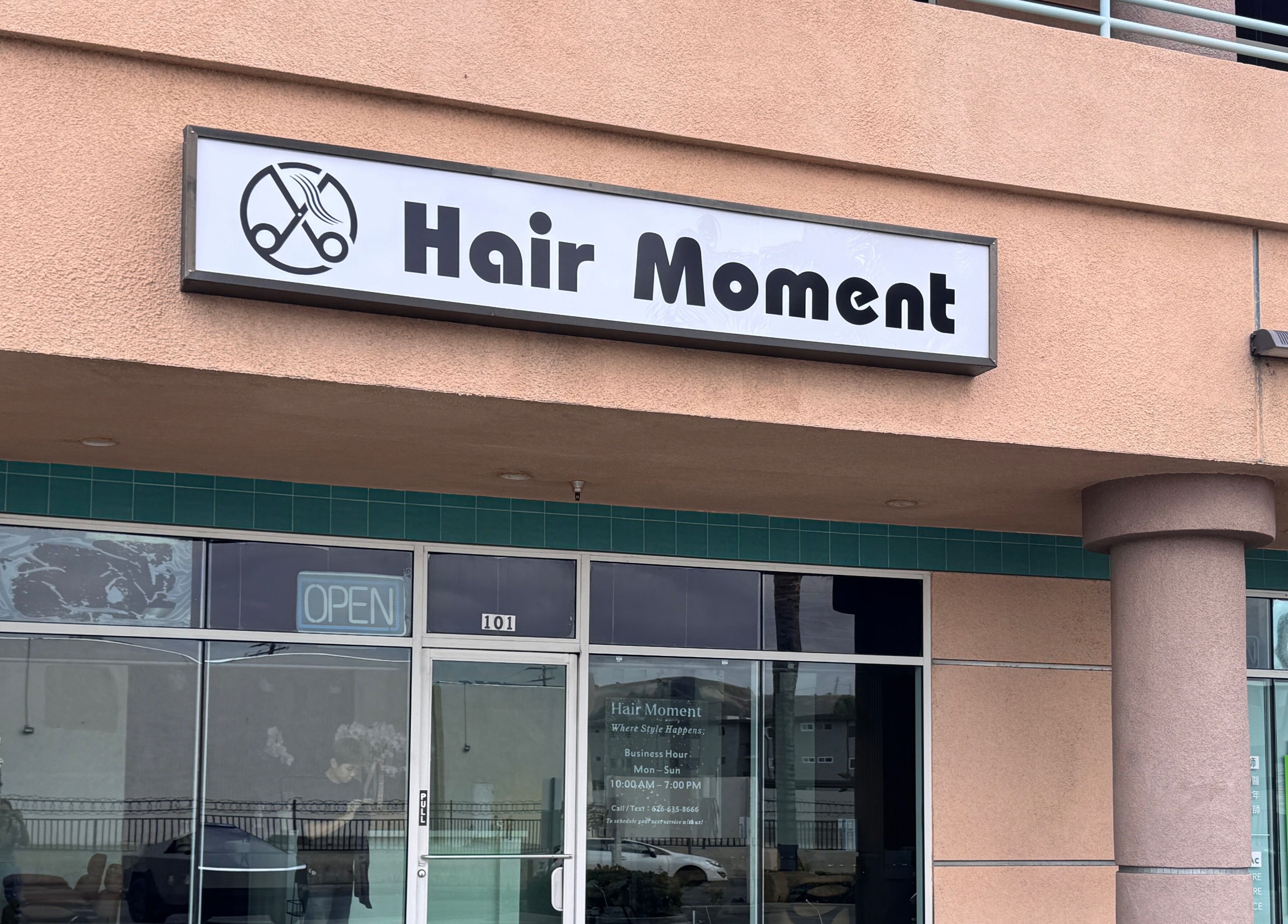 Hair Moment salon entrance in Rowland Heights, California, US, with modern signage.