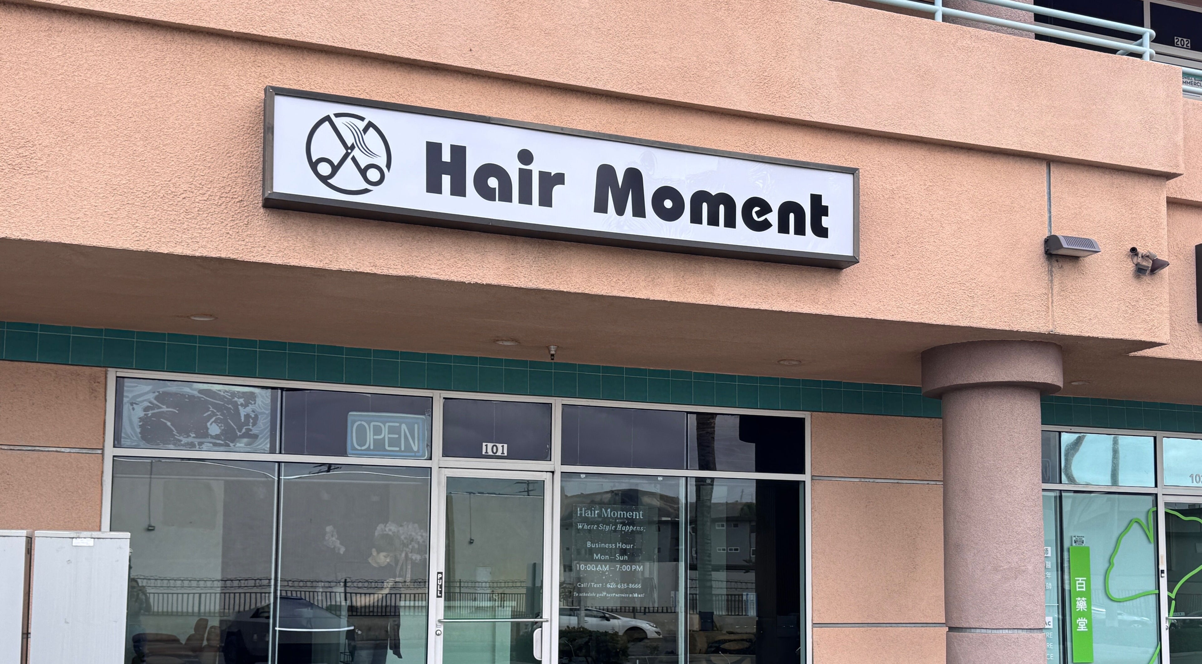 Hair Moment salon entrance in Rowland Heights, California, US, with modern signage.