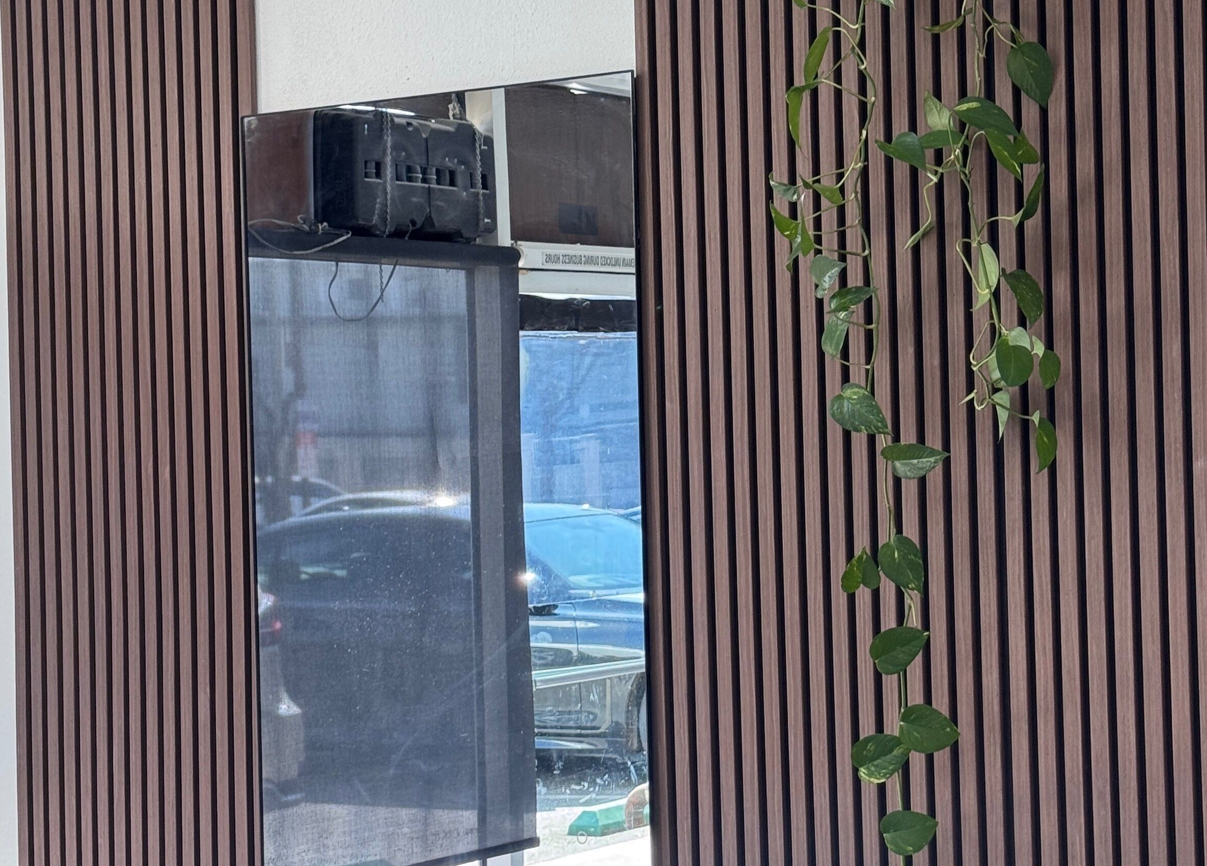 Elegant wood panel wall with hanging plant at Hair Moment, Rowland Heights, California, US.