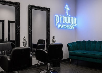 Luxurious interior of PRODIGY HAIR SESSIONS, Melbourne, Victoria, AU, featuring chic mirrors and plush seating.