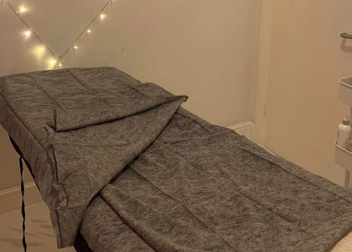 Cozy treatment room at Dream Therapy, Sunderland, England, GB, with a prepared massage table and ambient lighting.