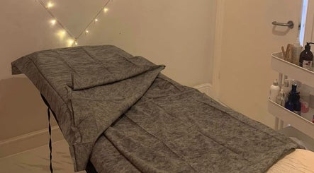 Cozy treatment room at Dream Therapy, Sunderland, England, GB, with a prepared massage table and ambient lighting.
