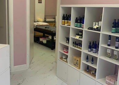 Product shelves in Dream Therapy, Sunderland, England, GB displaying wellness products and treatment room.