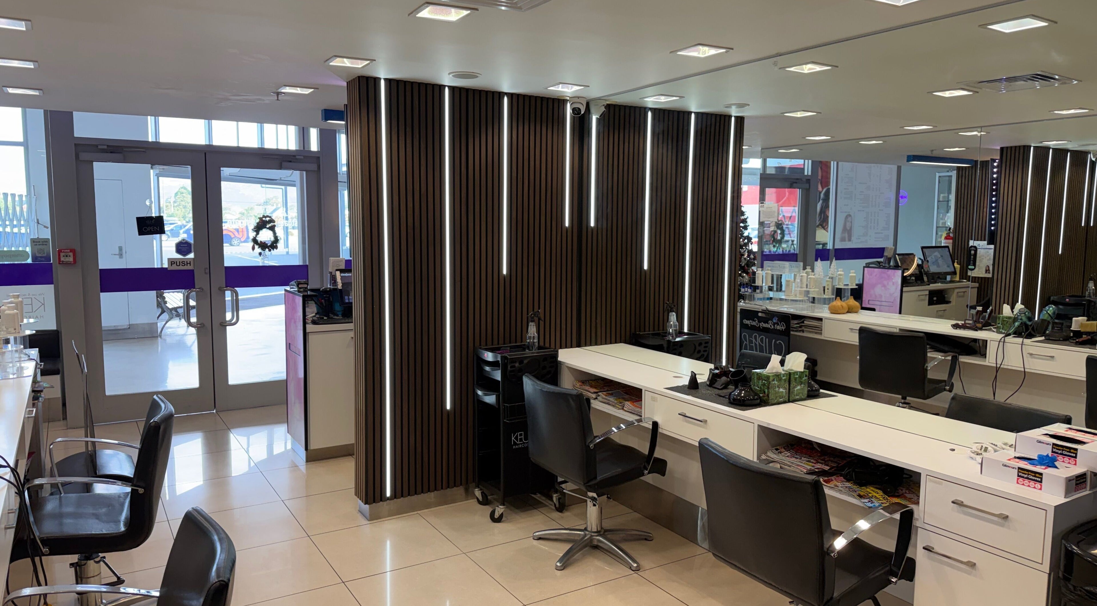 Modern salon interior at Hair Beauty Eastgate, Christchurch, Canterbury, NZ, showcasing sleek styling stations.