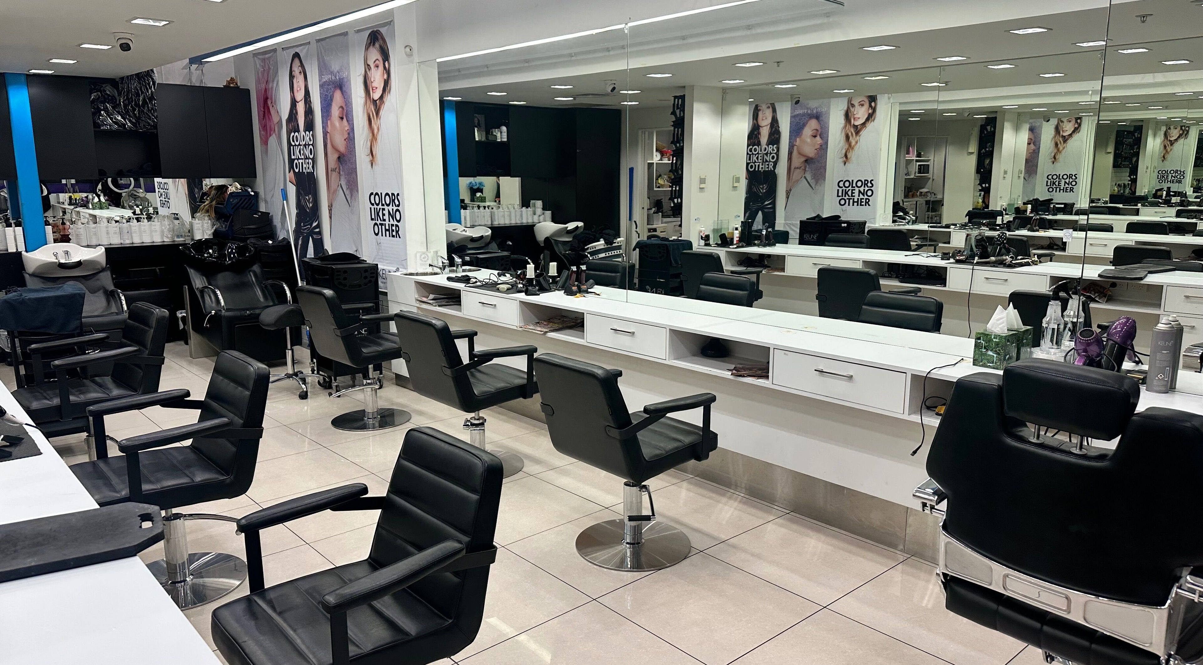 Modern salon interior at Hair Beauty Eastgate in Christchurch, Canterbury, NZ, featuring sleek styling chairs.