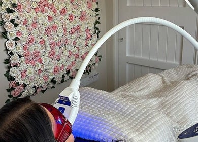 Client receiving LED therapy at NK Nail & Beauty Bar, Moate, County Westmeath, IE in a floral decor room.