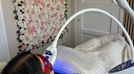 Client receiving LED therapy at NK Nail & Beauty Bar, Moate, County Westmeath, IE in a floral decor room.