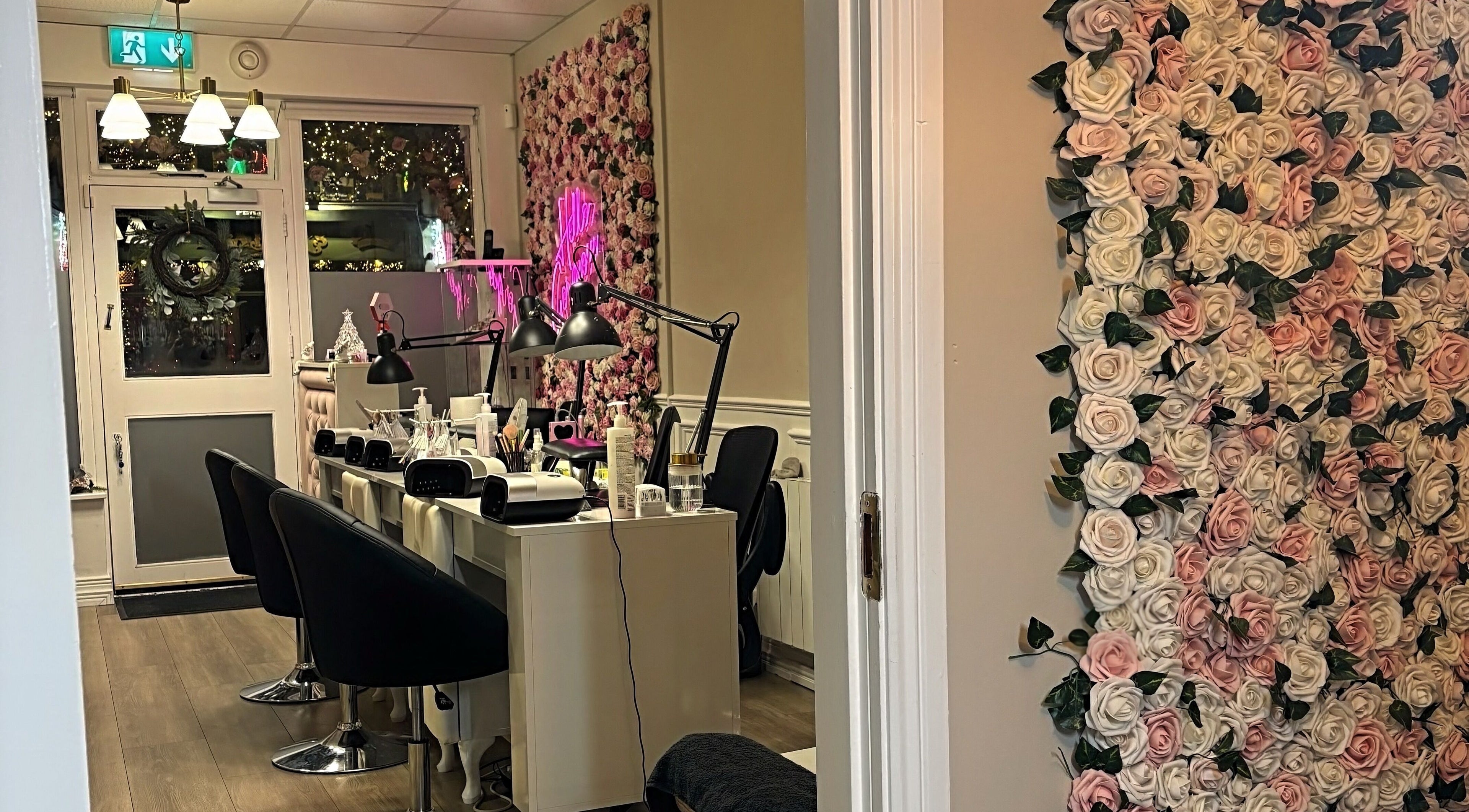 Inside NK Nail & Beauty Bar, Moate, County Westmeath, IE. Elegant decor with floral wall and nail stations.