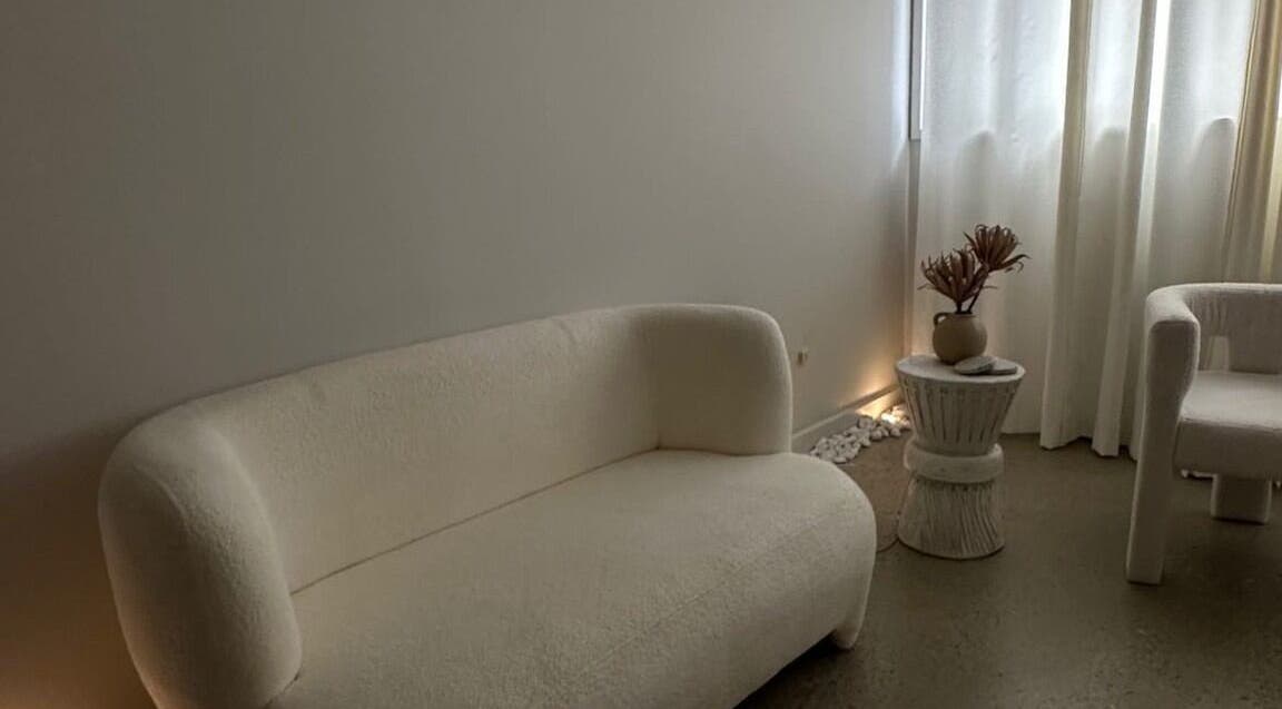 Elegant waiting area at Glow Szn, Condell Park, New South Wales, AU, featuring plush seating and soft lighting.