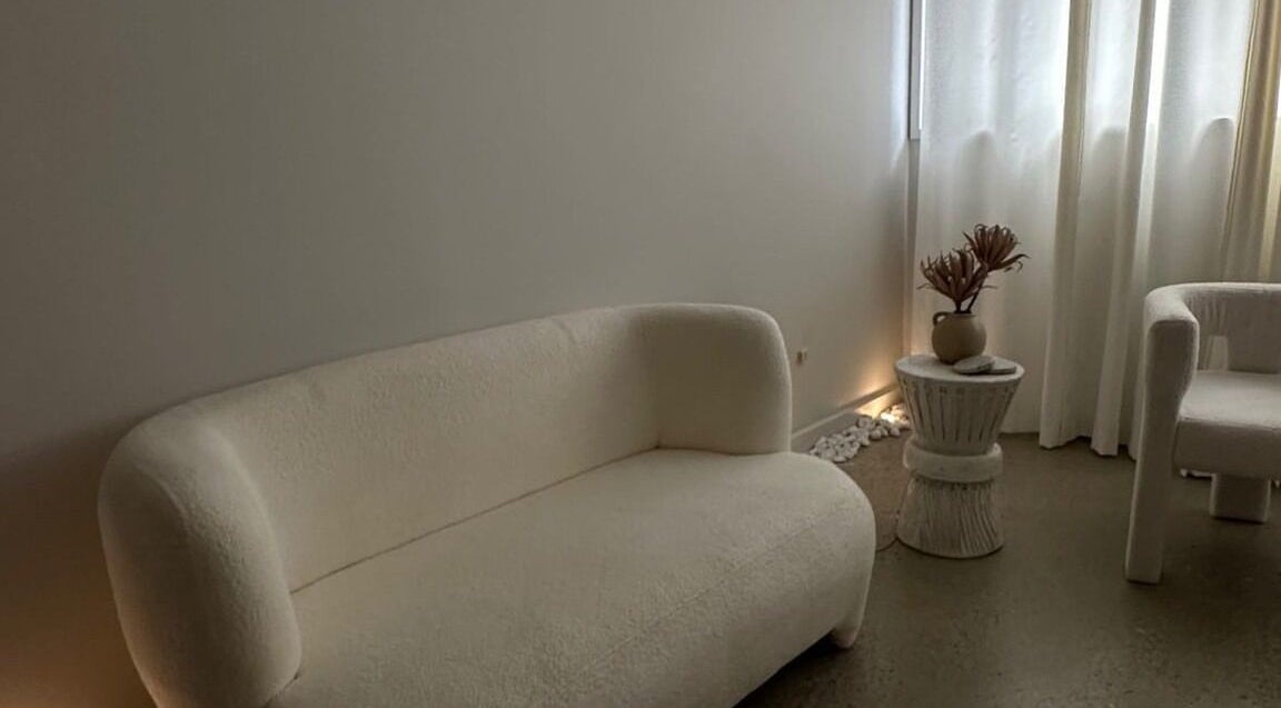 Elegant waiting area at Glow Szn, Condell Park, New South Wales, AU, featuring plush seating and soft lighting.