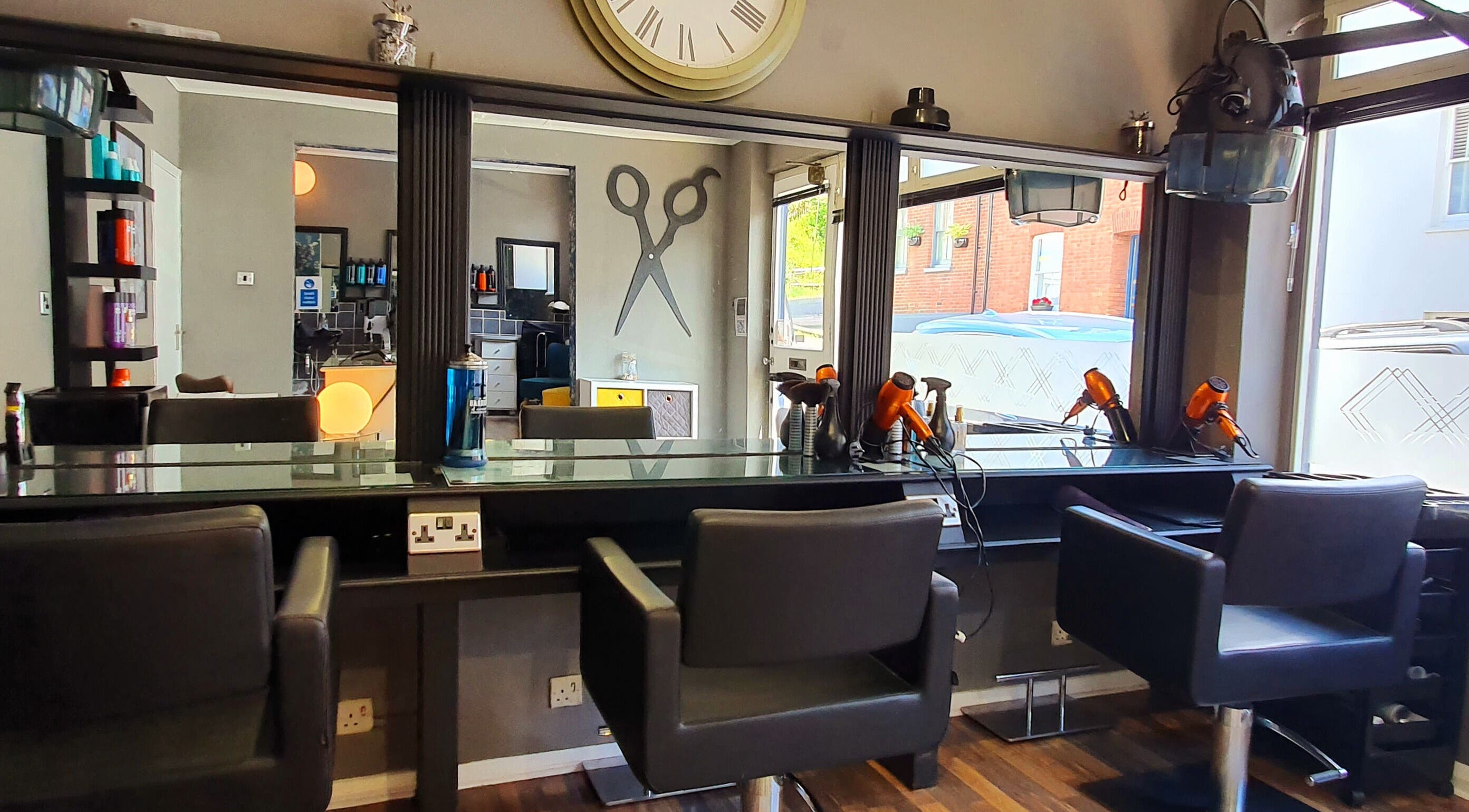 Modern salon chairs and mirrors at Shape Hair and Beauty, Lewes, England, GB, showcasing sleek interior design.