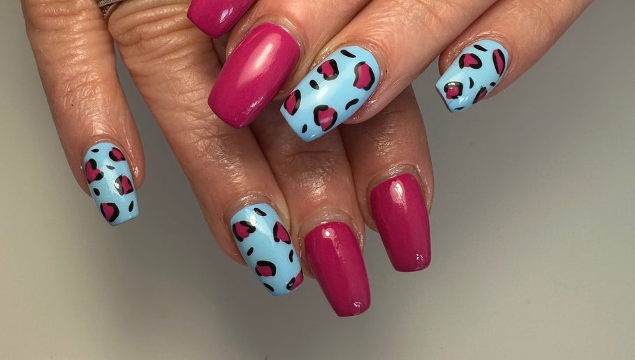 Vibrant pink and blue nail art at A Touch of Colour, Eastleigh, England, GB.