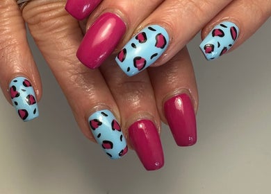 Vibrant pink and blue nail art at A Touch of Colour, Eastleigh, England, GB.