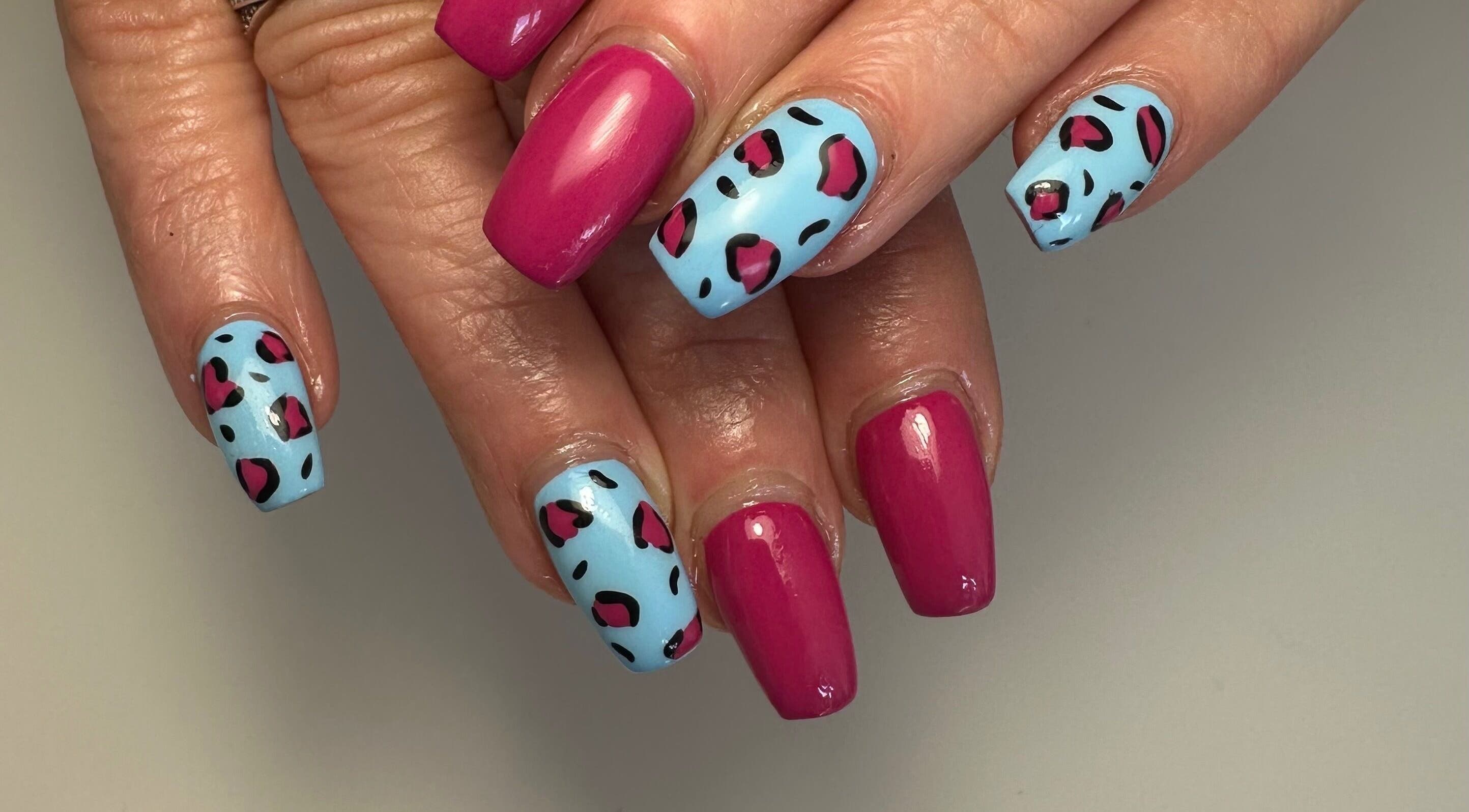Vibrant pink and blue nail art at A Touch of Colour, Eastleigh, England, GB.