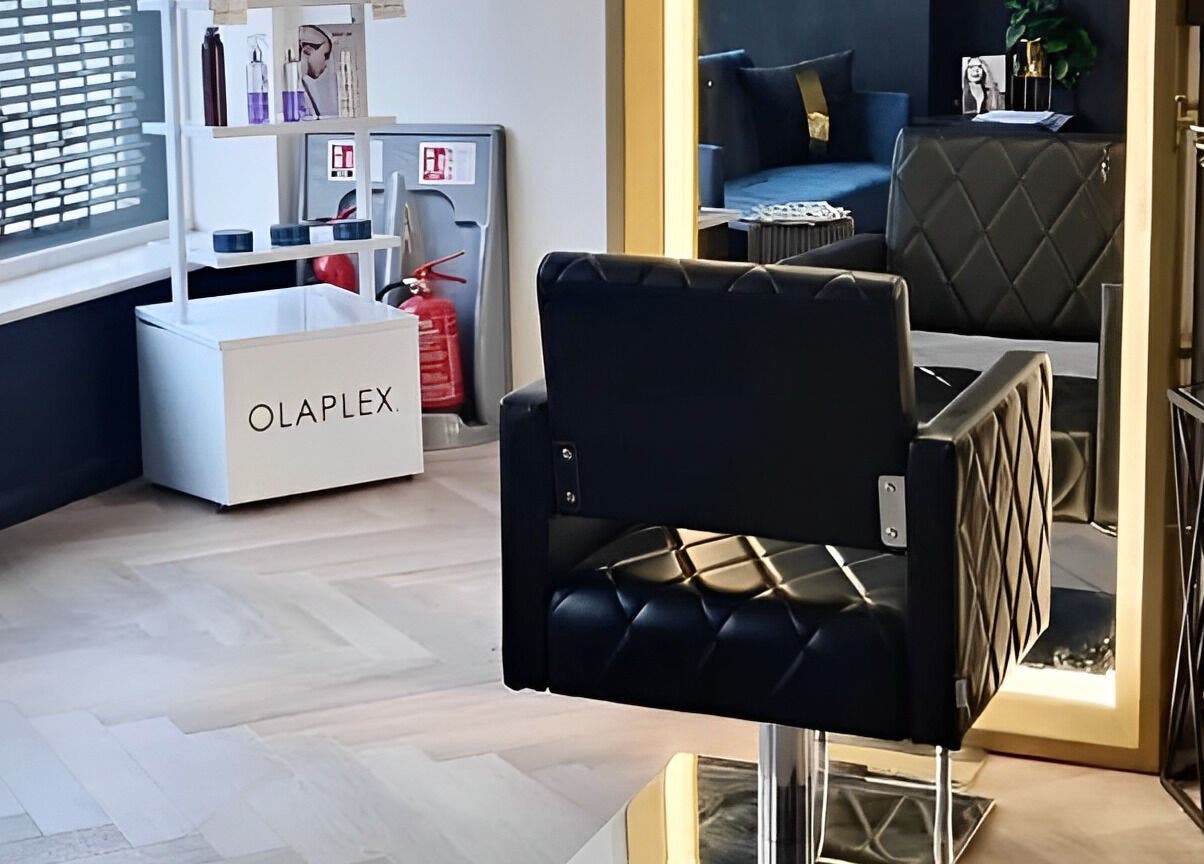 Stylish salon interior at E.L.M Academy, Bacup, England, GB featuring elegant chair and Olaplex products.