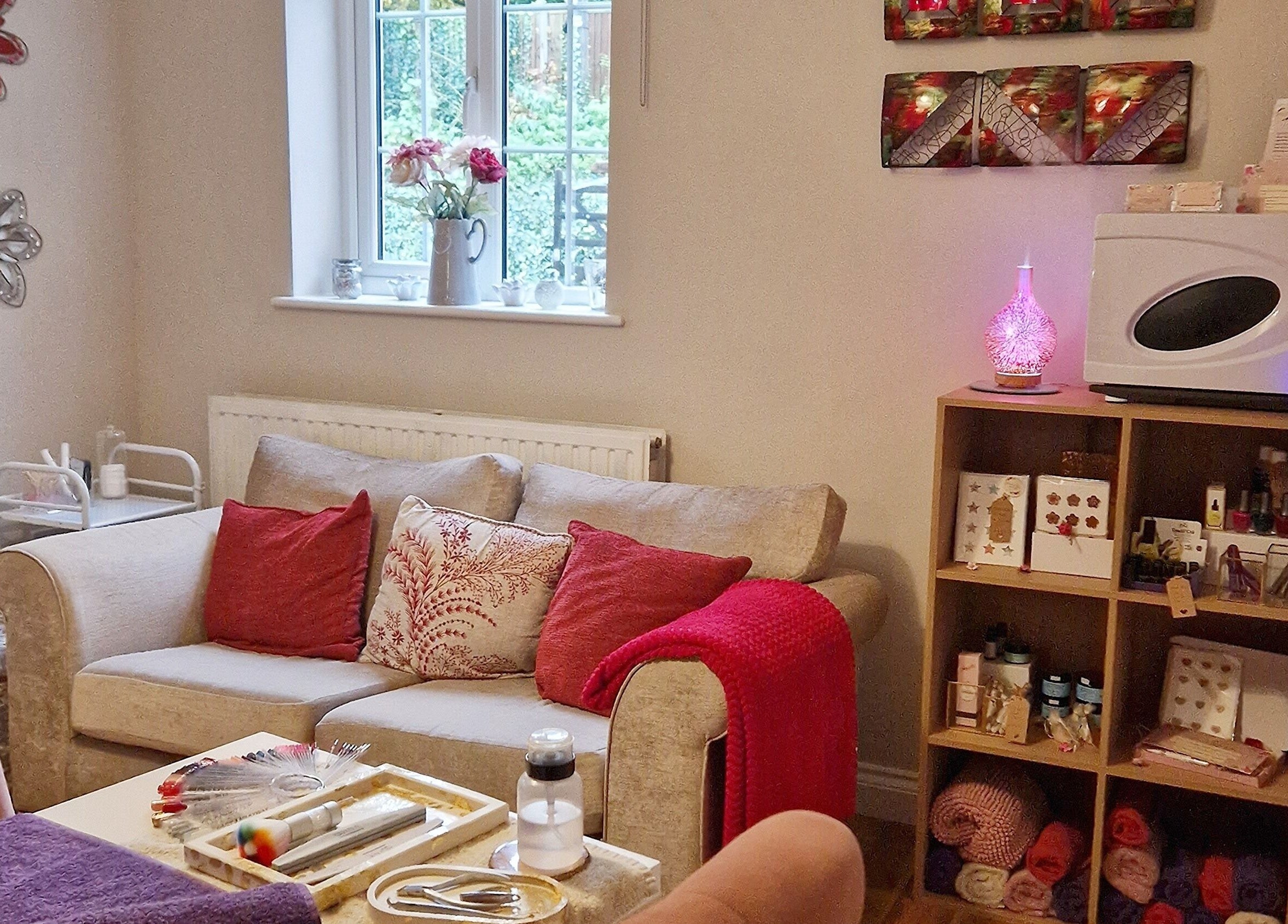 Radiant Rose Beauty Room's inviting interior in Salisbury, England features cozy seating and elegant decor.
