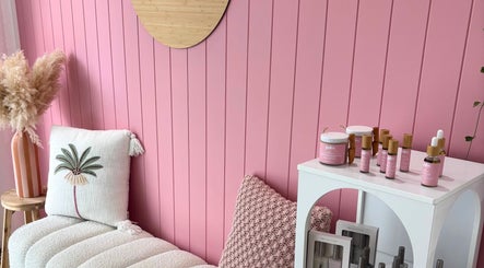 Palm Beauty Noosa cozy corner in Noosaville, Queensland, AU, featuring pink decor and beauty products.