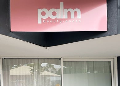 Entrance of Palm Beauty Noosa in Noosaville, Queensland, AU, showcasing the salon's sleek modern design.