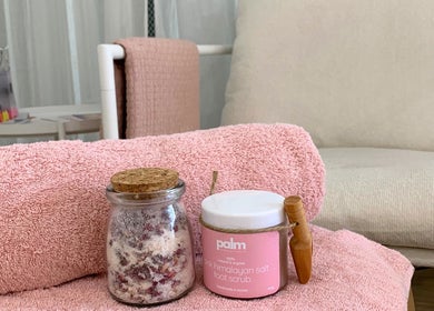 Pink towels and Himalayan salt scrub at Palm Beauty Noosa, Noosaville, Queensland, AU offering a calming spa experience.
