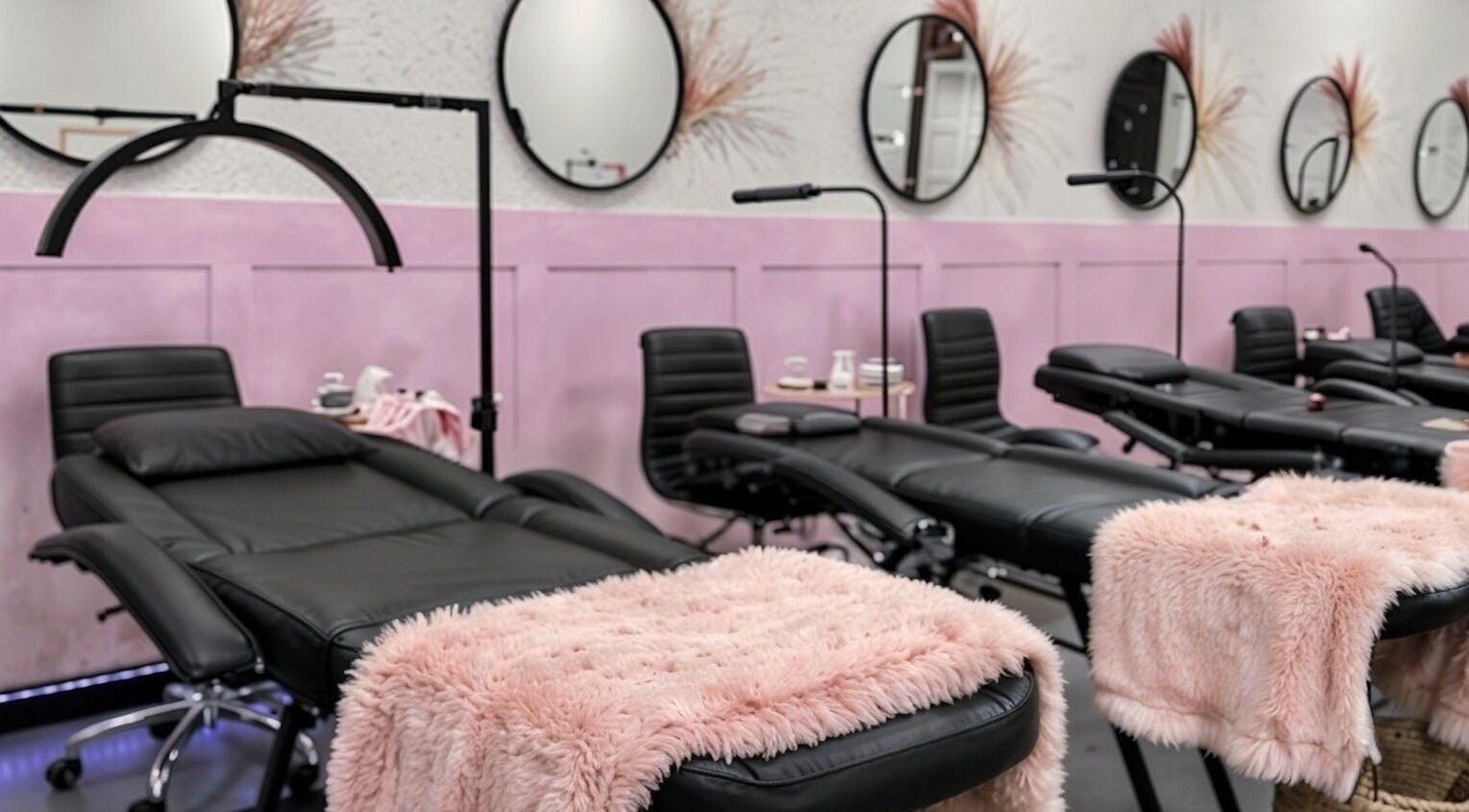 Luxurious reclining chairs in Babe Cave Studio, River Oaks, Texas, US adorned with pink throws.