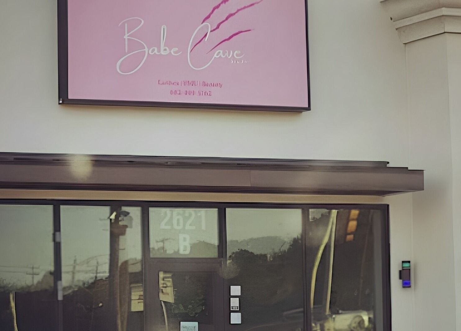 Exterior view of Babe Cave Studio in River Oaks, Texas, featuring stylish signage.