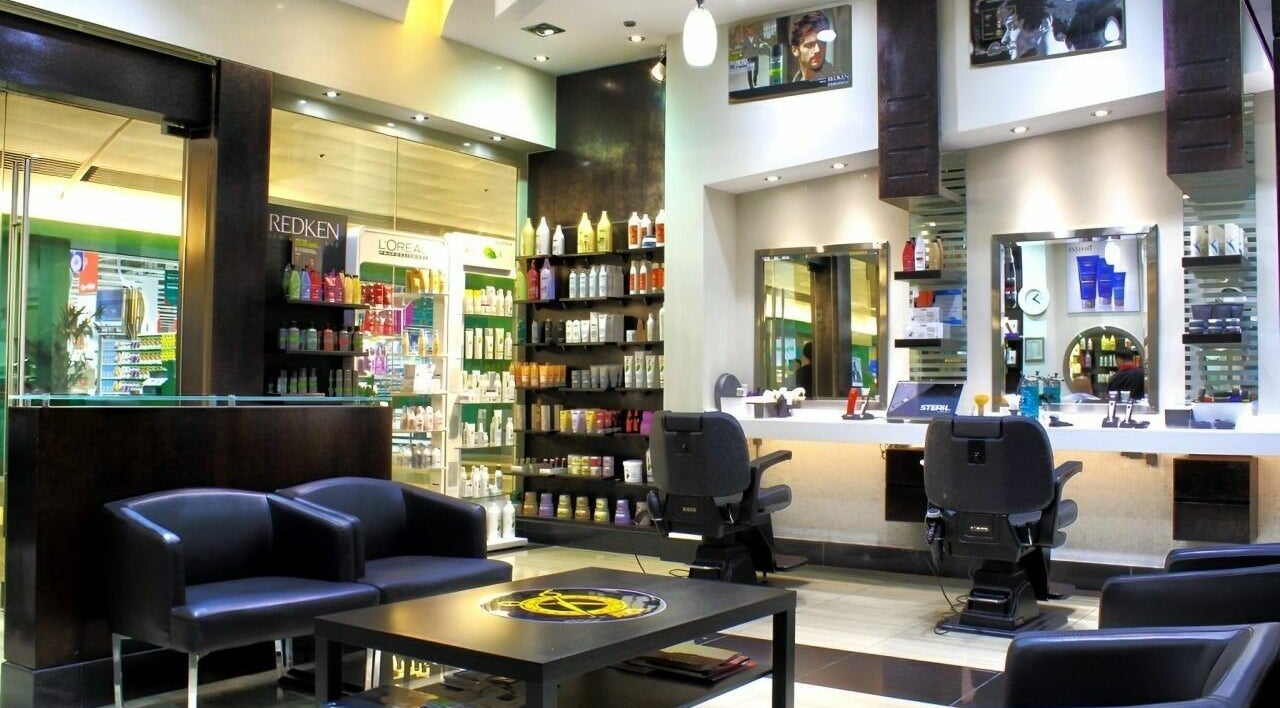 Sophisticated interior of The Barber Room in Dubai, AE, featuring modern chairs and vibrant product displays.