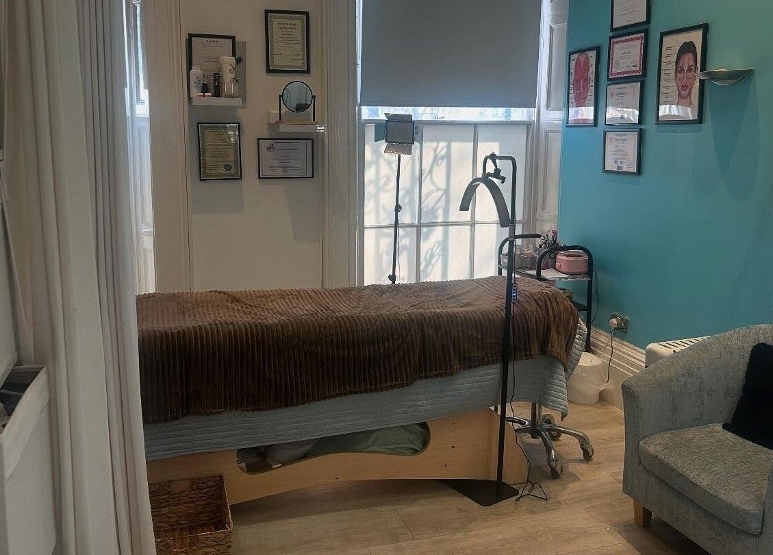 Cozy treatment room at Hepburns on the Prom, Cheltenham, England, GB, featuring a comfortable spa bed and ambient lighting.
