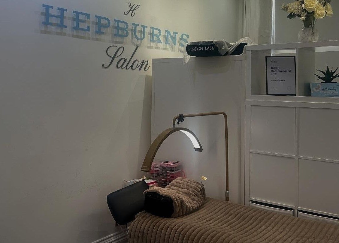 Cozy treatment room at Hepburns on the Prom, Cheltenham, England, GB with comfortable bed and calming decor.