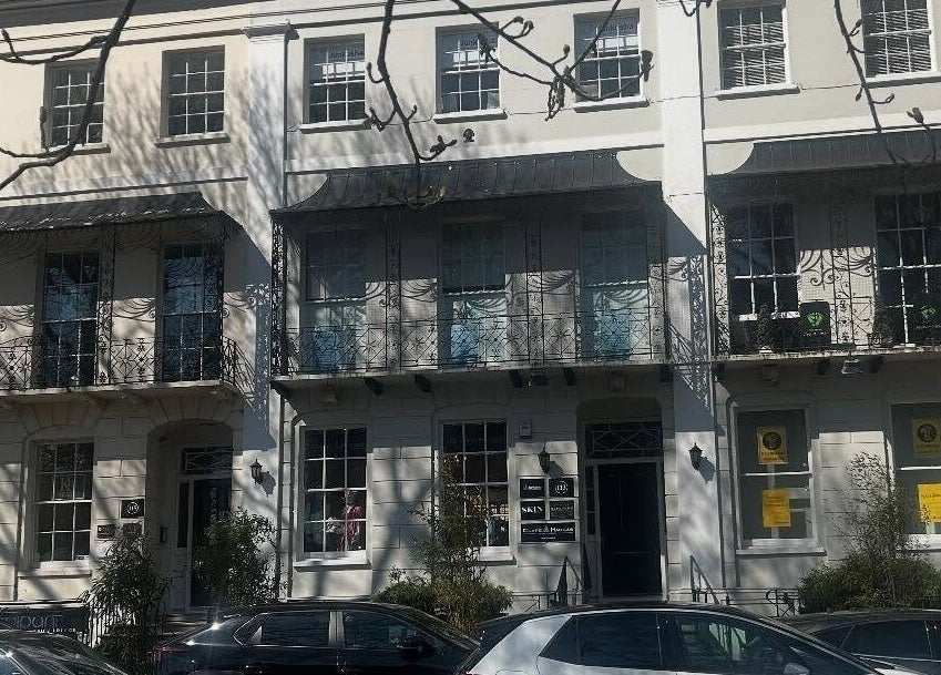 Hepburns on the Prom in Cheltenham, England, GB featuring a classic facade with decorative ironwork.