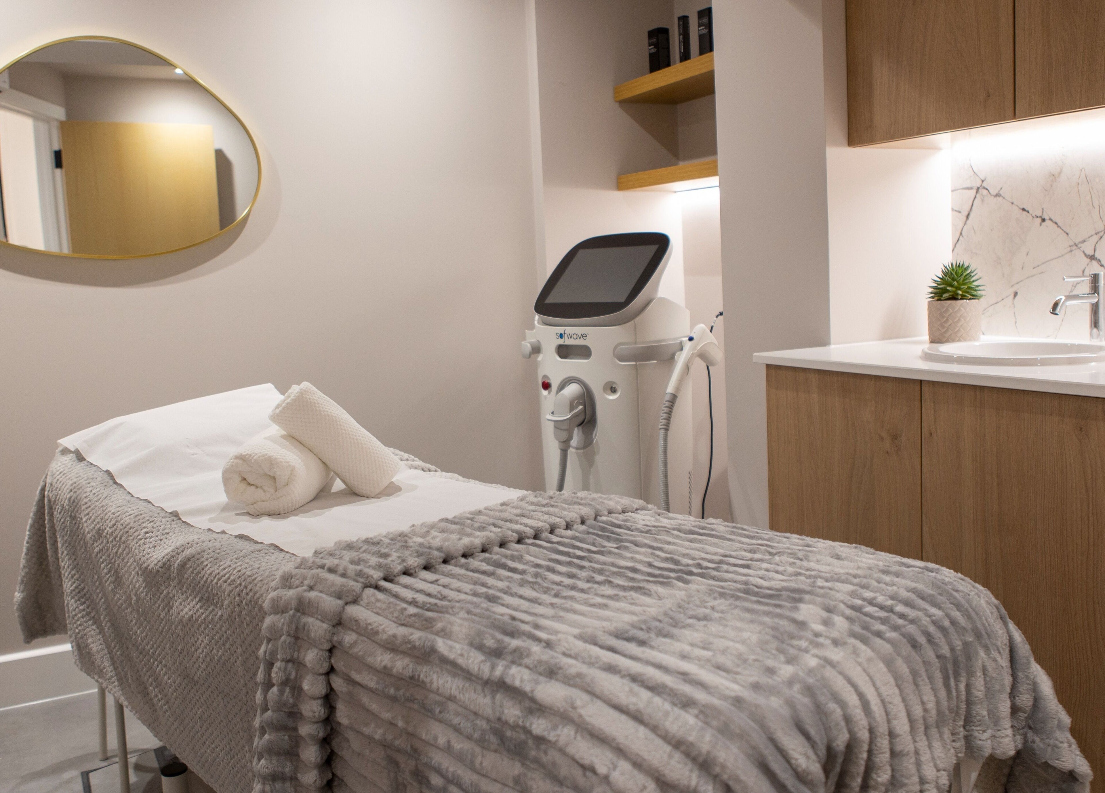 Relaxing treatment room at Beata Durtan at Atelier Clinic, Egham, England, GB, featuring a cozy massage bed.