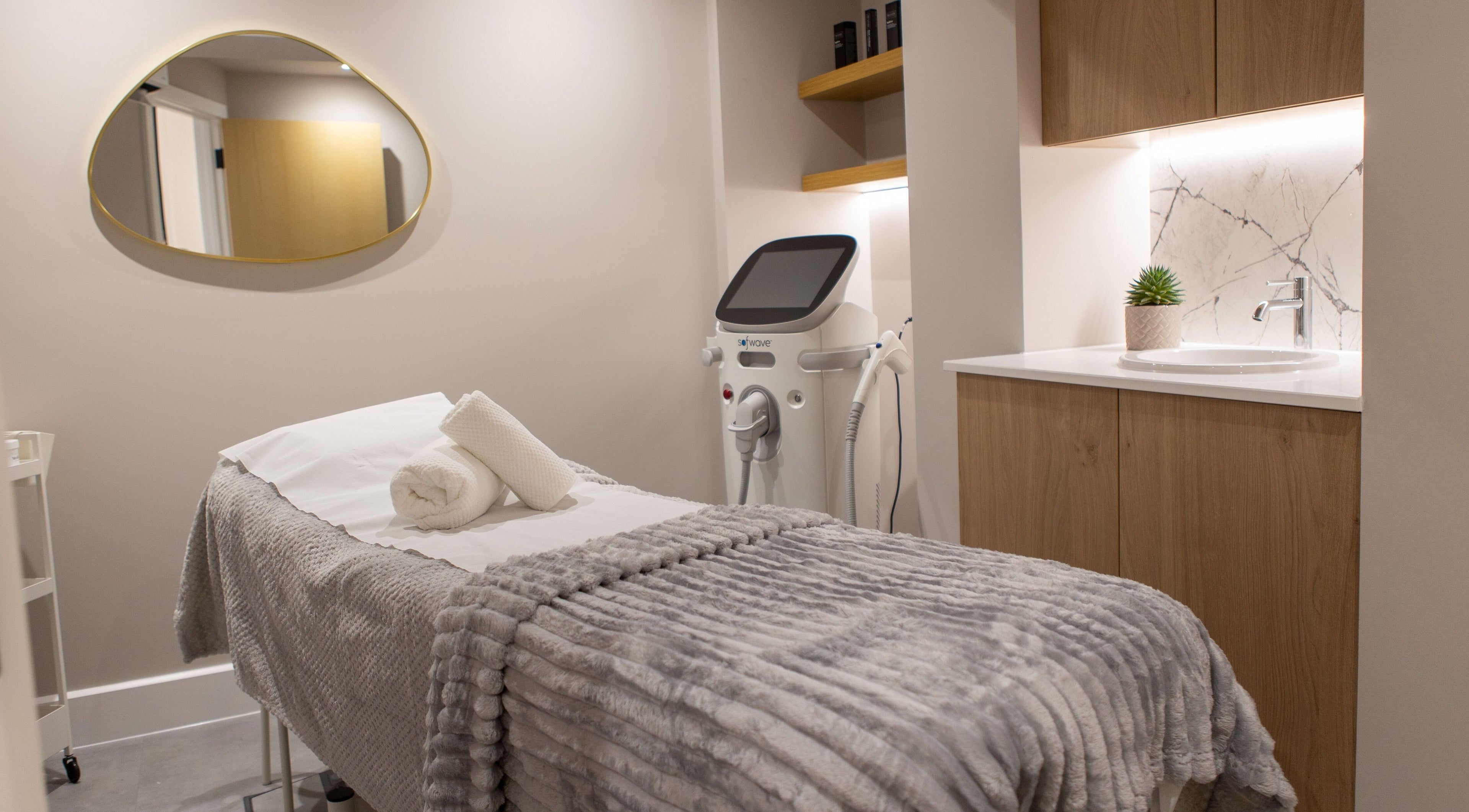 Relaxing treatment room at Beata Durtan at Atelier Clinic, Egham, England, GB, featuring a cozy massage bed.
