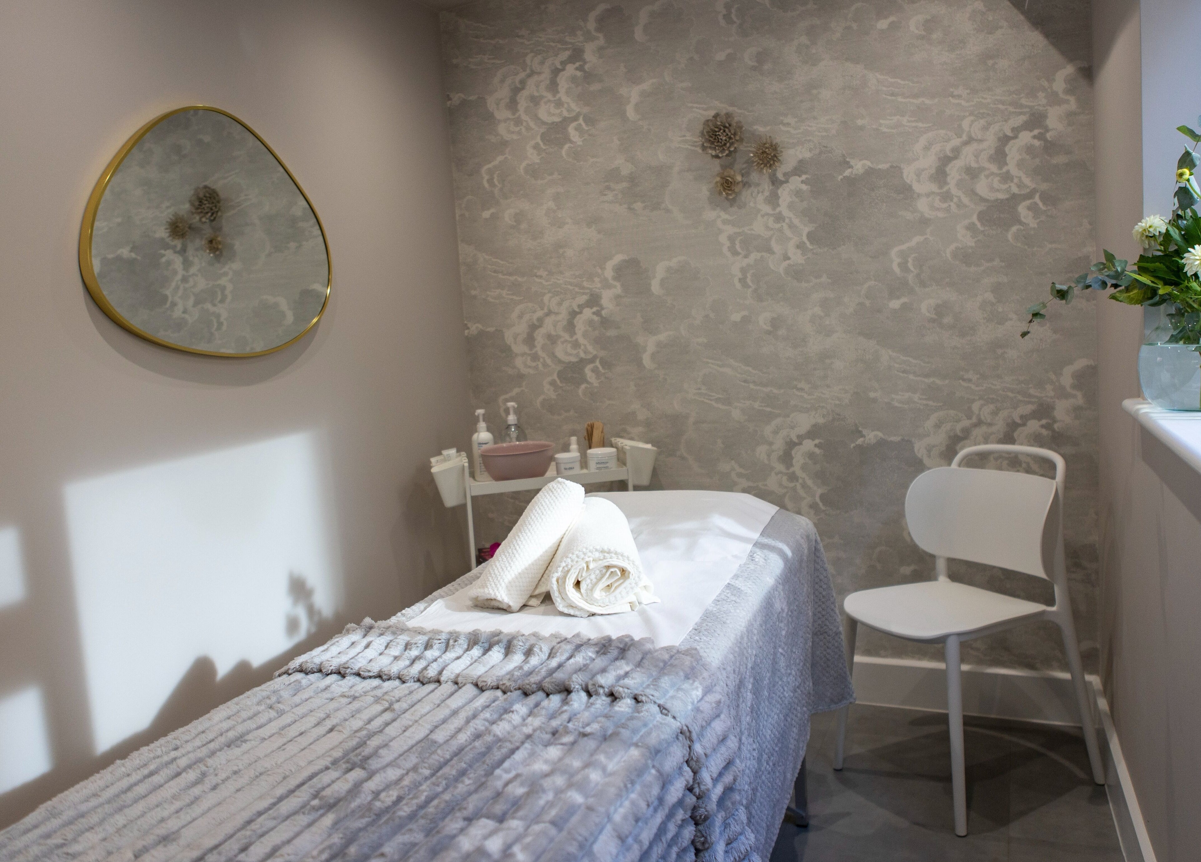 Tranquil spa room at Beata Durtan at Atelier Clinic, Egham, featuring a treatment bed and calming decor.