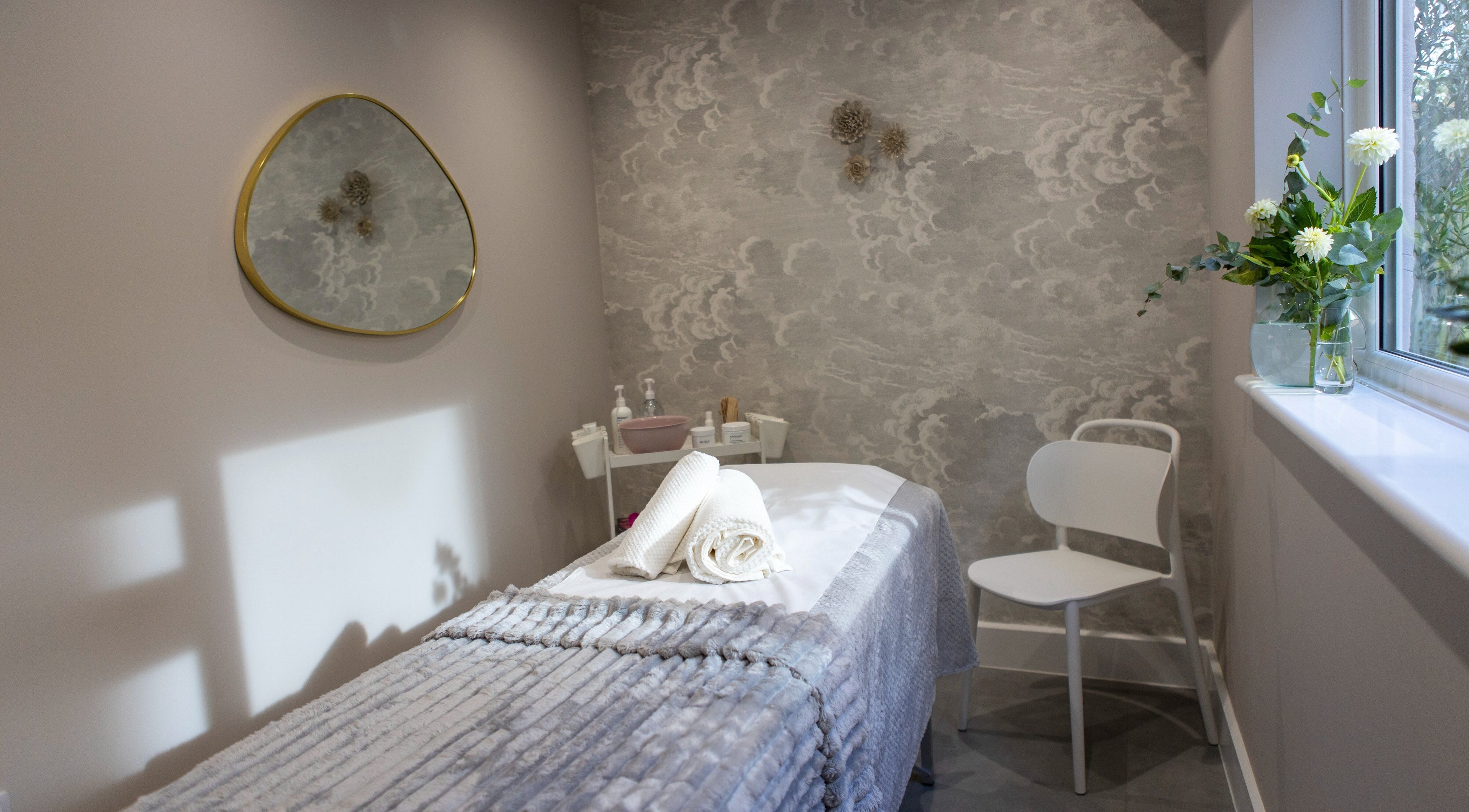 Tranquil spa room at Beata Durtan at Atelier Clinic, Egham, featuring a treatment bed and calming decor.