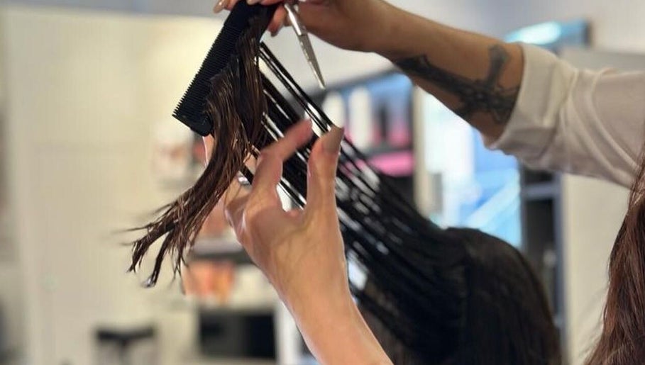 Stylist expertly cutting hair at Leo & Simon Salon, Windsor, England, GB. Experience professional salon services.